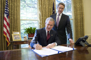 With Sen. Bill Frist (R-Tenn.) looking on, President George W. Bush signs into law S. 3728, the North Korea Nonproliferation Act of 2006.